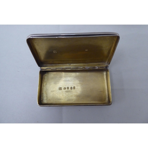 56 - A George III silver snuff box with a hinged, ribbed body  London 1802
