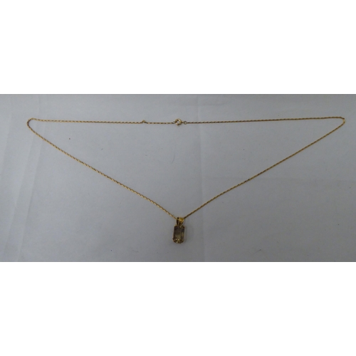 59 - A Bahrainian yellow metal topaz pendant, on a fine bar link chain