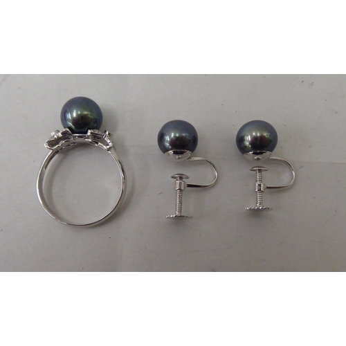 61 - A suite of black pearl jewellery, comprising a ring, necklace and a pair of earrings