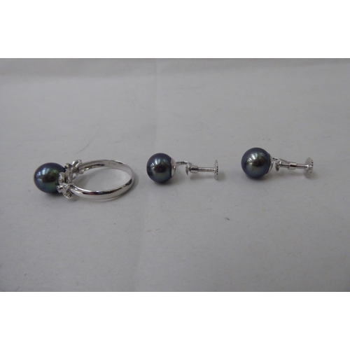 61 - A suite of black pearl jewellery, comprising a ring, necklace and a pair of earrings