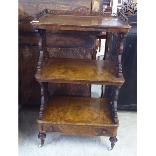 10 - A late Victorian burr walnut finished and mahogany three tier whatnot, on a base drawer plinth, turn... 