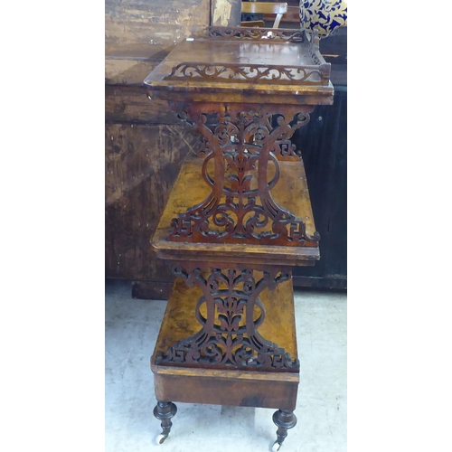 10 - A late Victorian burr walnut finished and mahogany three tier whatnot, on a base drawer plinth, turn... 
