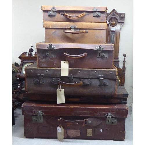 14 - Mainly late 19thC early stitched brown hide suitcases  largest 11