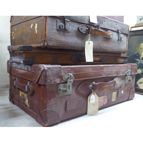 14 - Mainly late 19thC early stitched brown hide suitcases  largest 11