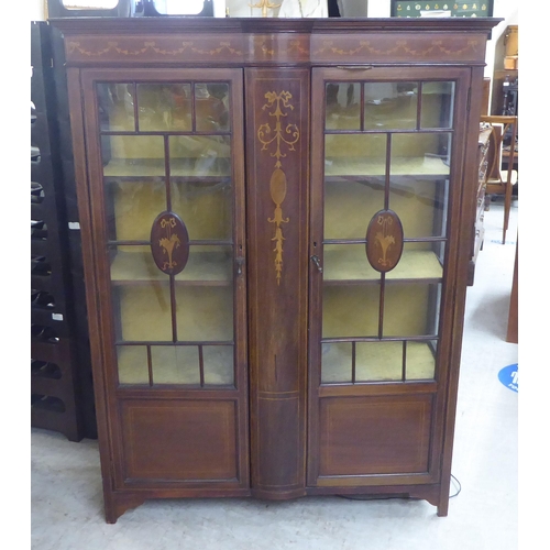 16 - An Edwardian string inlaid mahogany china cabinet with a pair of glazed doors, enclosing three fixed... 