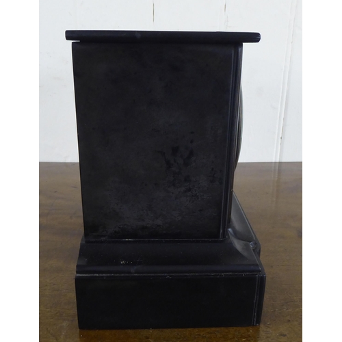 17 - A 1930s black slate cased mantel timepiece; faced by a Roman dial  8.5