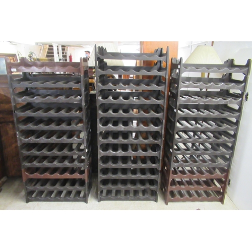 20 - A modern moulded plastic modular wine rack with thirty-four sections, each accommodating six bottles... 