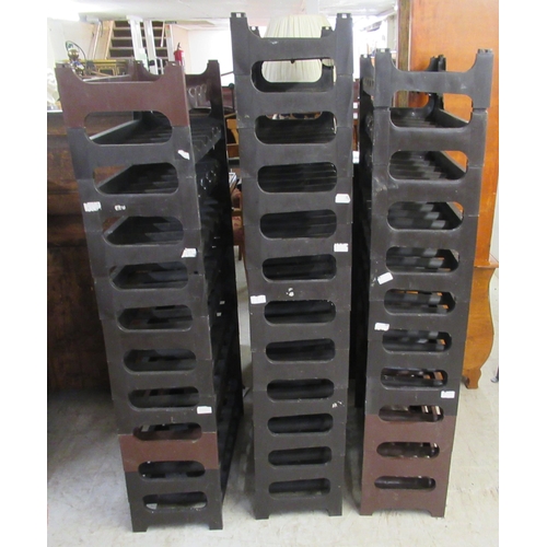 20 - A modern moulded plastic modular wine rack with thirty-four sections, each accommodating six bottles... 