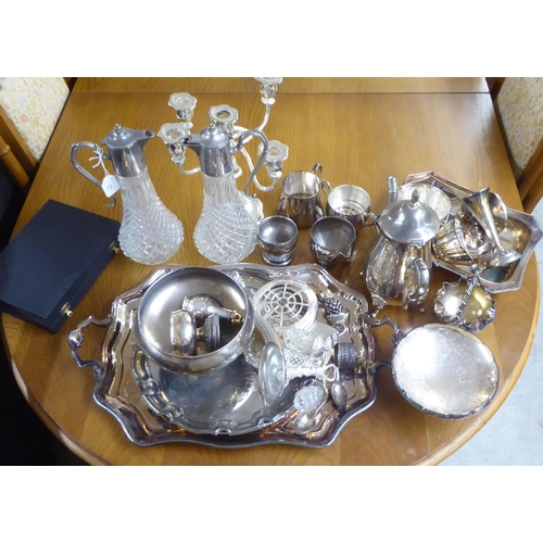 21 - Silver plated tableware: to include a pair of glass claret jugs