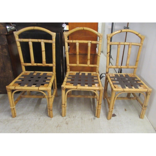22 - A set of six modern bamboo effect and caned dining chairs with webbing seats, raised on straight leg... 