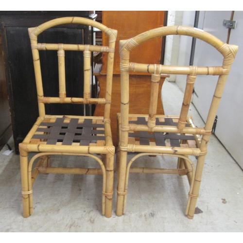 22 - A set of six modern bamboo effect and caned dining chairs with webbing seats, raised on straight leg... 