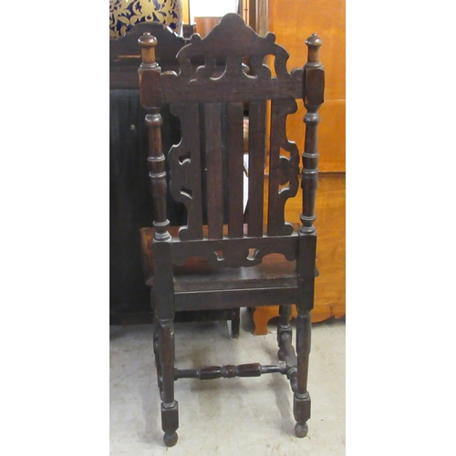 25 - A late 19thC carved and stained oak hall chair, the solid seat raised on turned and block forelegs