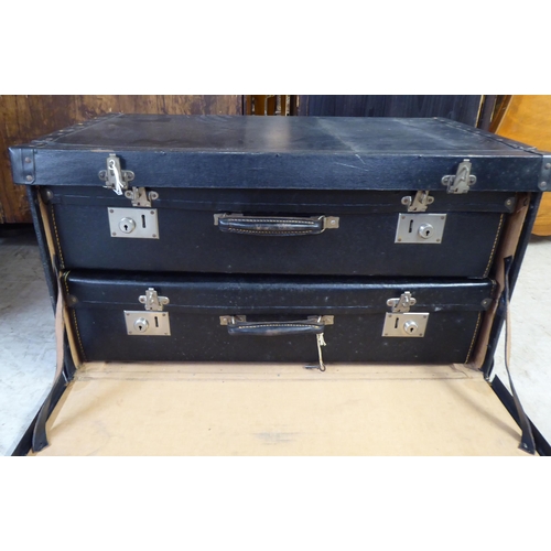 3 - An early/mid 20thC stud cased bound cabin trunk, the hinged lid and fall front containing two suitca... 