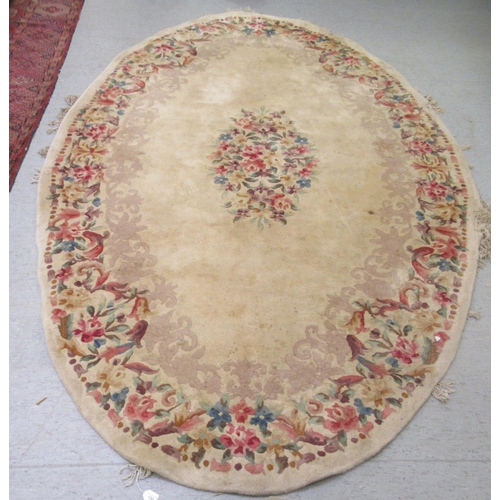 38 - A Chinese washed cotton rug, decorated in traditional taste in pastel tones  86