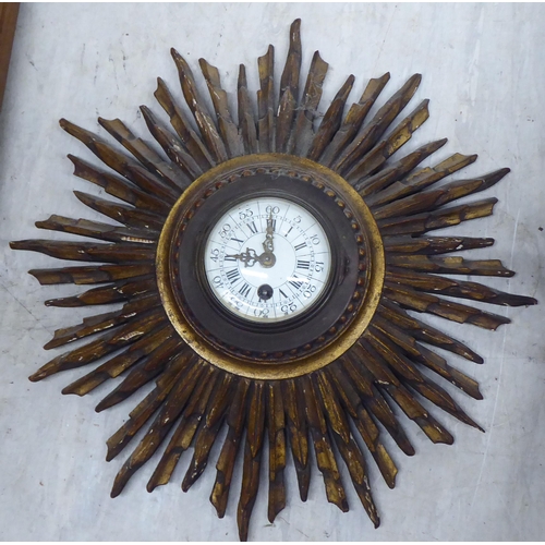 40 - An early/mid 20thC gilded sunburst design timepiece; faced by a Roman and Arabic dial  12
