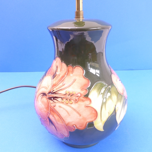 17 - A Moorcroft table lamp of Hibiscus pattern (24cm high x 18cm wide)