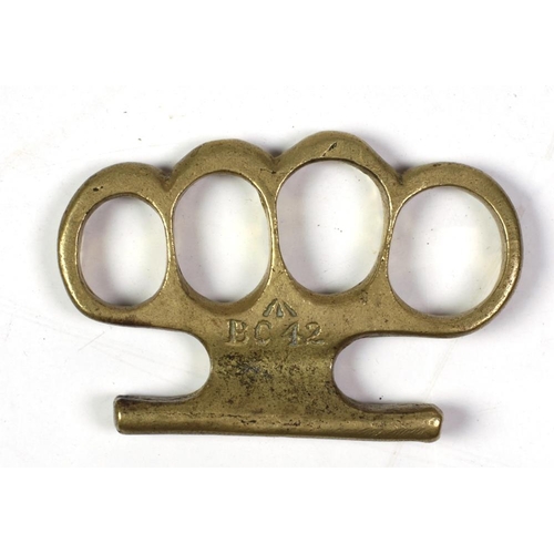 23 - A Victorian period brass Knuckle Duster, with mark BC42. (1)