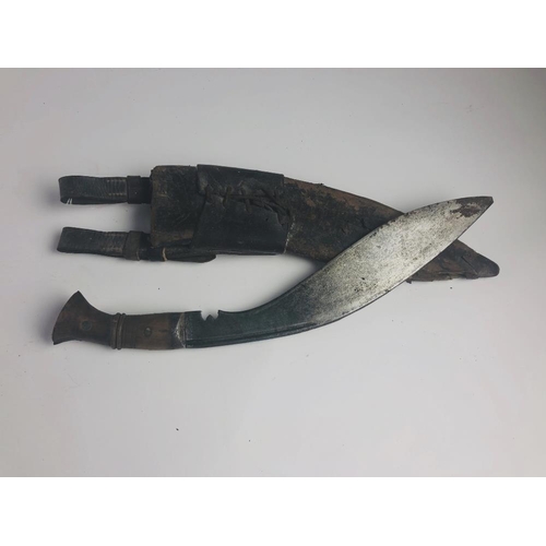 27 - An early 20th Century Kurkha, with shaped blade stamped 1915, with wooden handle and scabbard. (1)