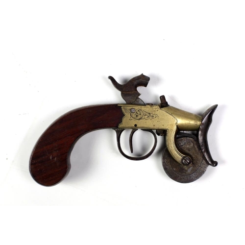 34 - An antique flintlock tinder box Gun, with engraved brass stock and wooden handle. (1)