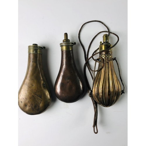 36 - Three antique copper Powder Flasks, two plain and one engraved. (3)