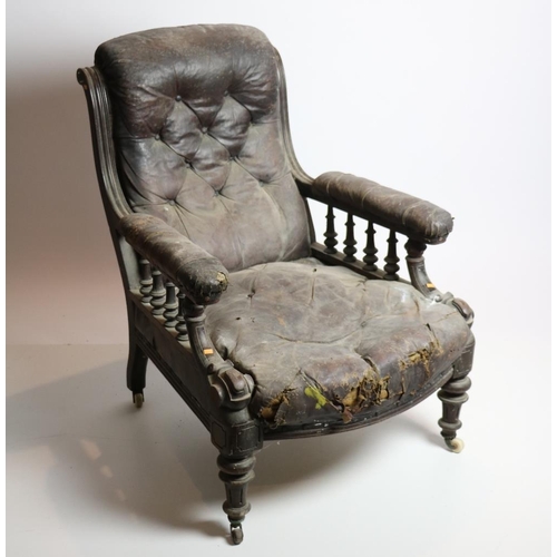 32 - A carved Edwardian walnut Library Armchair, covered in hide. (1)