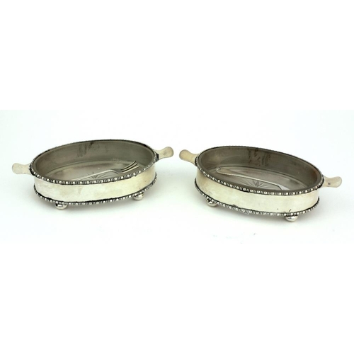 36 - An attractive pair of oval shaped glass lined silver Butter Dishes, with two forks. (4)Provenance: T... 