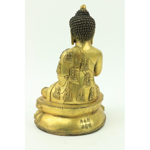 24 - A fine quality large Chinese gilt bronze Figure, of a Buddha, seated on a double lotus base, the lef... 