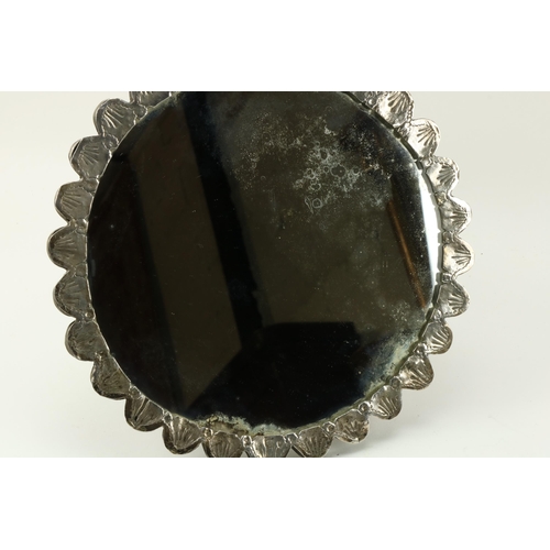21 - An attractive modern shield shaped silver Dressing Table Mirror, with profusely embossed frame; and ... 