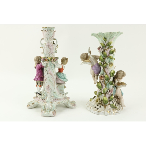 38 - A Sitzendorf porcelain Table Lamp, with flowers and two cupids surmounted; and a Sitzendorf Centerpi... 
