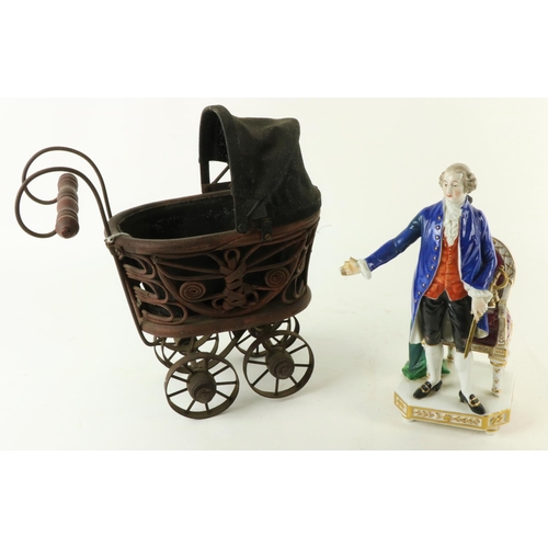 49 - A miniature cane-work Dolls Pram, with canvas top and metal undercarriage; and a Continental porcela... 