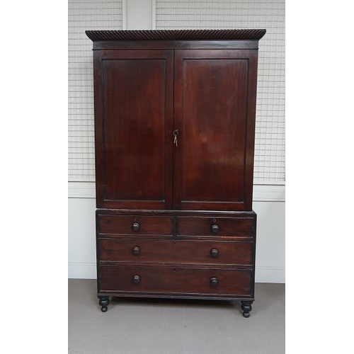 22 - An early 19th century mahogany linen press, rope twist pediment above two panel doors and two short ... 