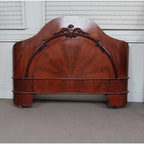 29 - A Victorian mahogany bed, with arched upholstered bed head and panel end, 152 cms wide, 210 cms long... 