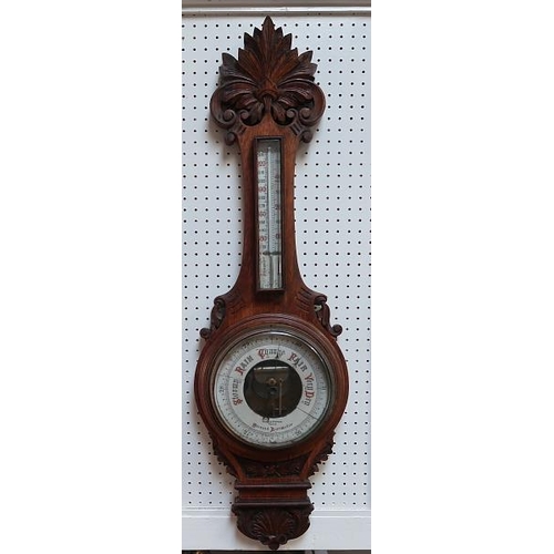 35 - A Victorian aneroid banjo shaped barometer, in oak case by Hopkins and Hopkins, Dublin, 95 cms high.