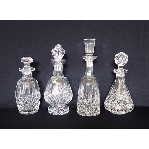 17 - Four various Waterford crystal decanters and various stoppers, height 34, 30 & 18 x 2 cms.