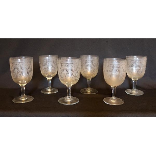 28 - A set of six early 20th century wine glasses with engraved floral motif, height 15 cms.