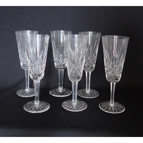 34 - A set of six Waterford crystal champagne flutes, height 19 cms.