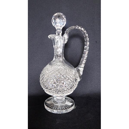 36 - A Waterford crytal decanter and stopper on stepped circular base, height 30 cms.