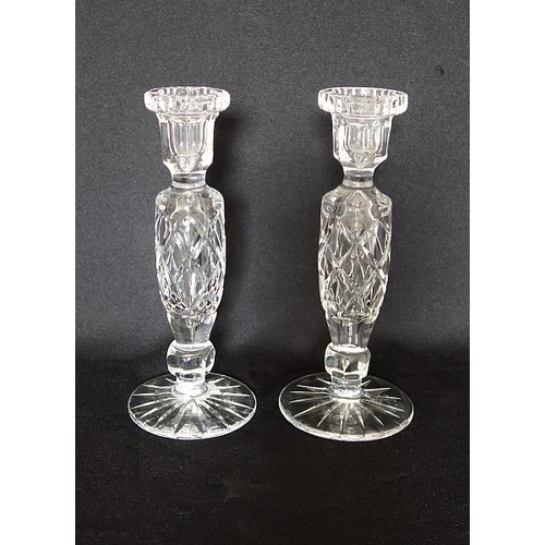 37 - A pair of cut glass Wedgwood candlesticks raised on circular base, height 21.5 cms.