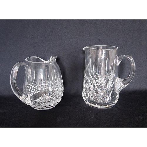 41 - Two Waterford crystal jugs, height 16 & 20 cms.