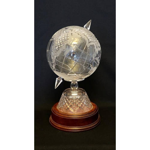 42 - A Cavan crystal model of  a globe on mahogany base, height 34 cms.
