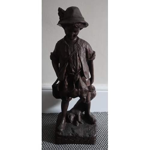 46 - An early 20th Century coal cast figure of a young hunter on square base, 57 cms high.