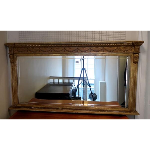 53 - An Edwardian gilt Adams style rectangular mirror, husk decorated frieze, patarae flanking capitals o... 