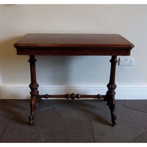 54 - A Victorian burr walnut rectangular card table, raised on fluted supports and scroll feet, joined by... 