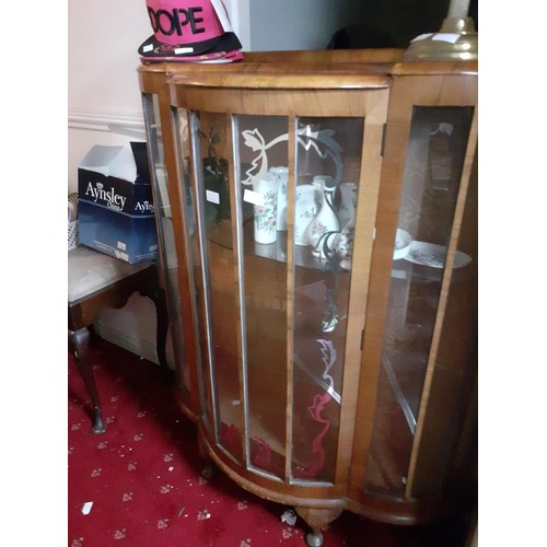 43 - A BOWED CHINA CABINET WITH SINGLE DOOR CRACK IN ONE PANEL