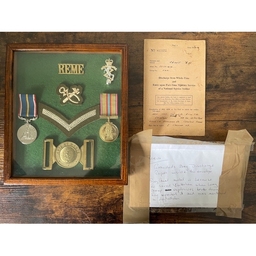 Framed Collection of 2 British Military Medals REME Badges / Buckle & Rank Insignia includes National Service medal & Suez Canal Medal + discharge papers mentioned in dispatches