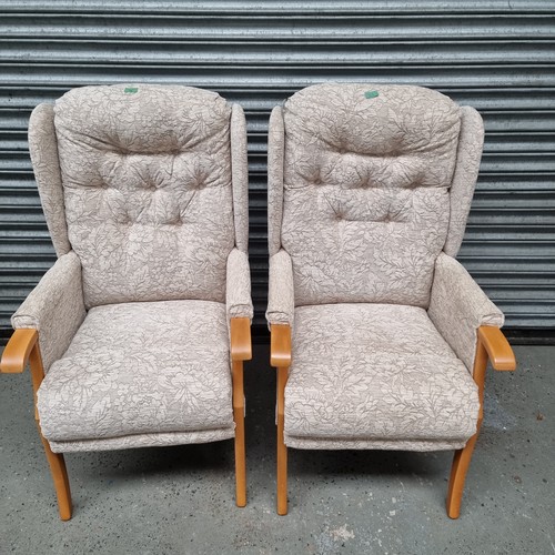 33 - Two wing backed modern arm chairs.