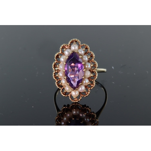15 - 9ct yellow gold ring set with central marquise shaped amethyst measuring approx. 19mm x 7mm, surroun... 