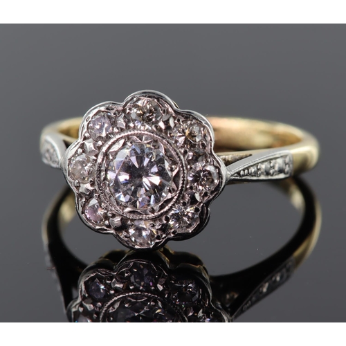 44 - 18ct yellow gold and platinum diamond daisy cluster ring consisting of central round brilliant cut d... 