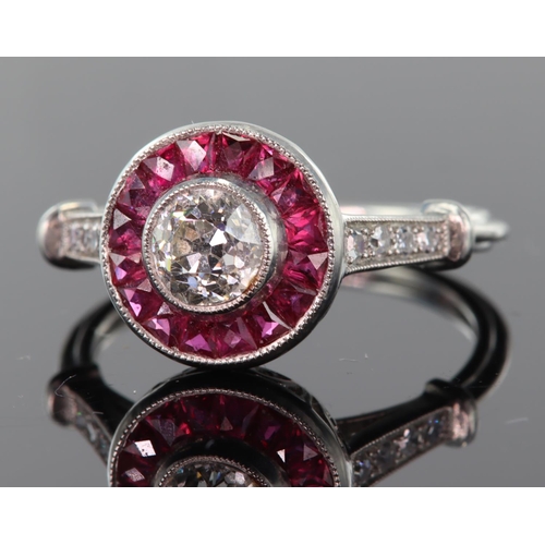 54 - Platinum diamond and ruby ring consisting of central round brilliant cut diamond calculated as weigh... 