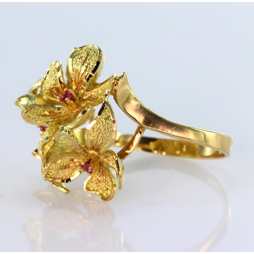 29 - High carat yellow gold dress ring depicting four flowers with ruby centre, finger size N, weight 5.7... 